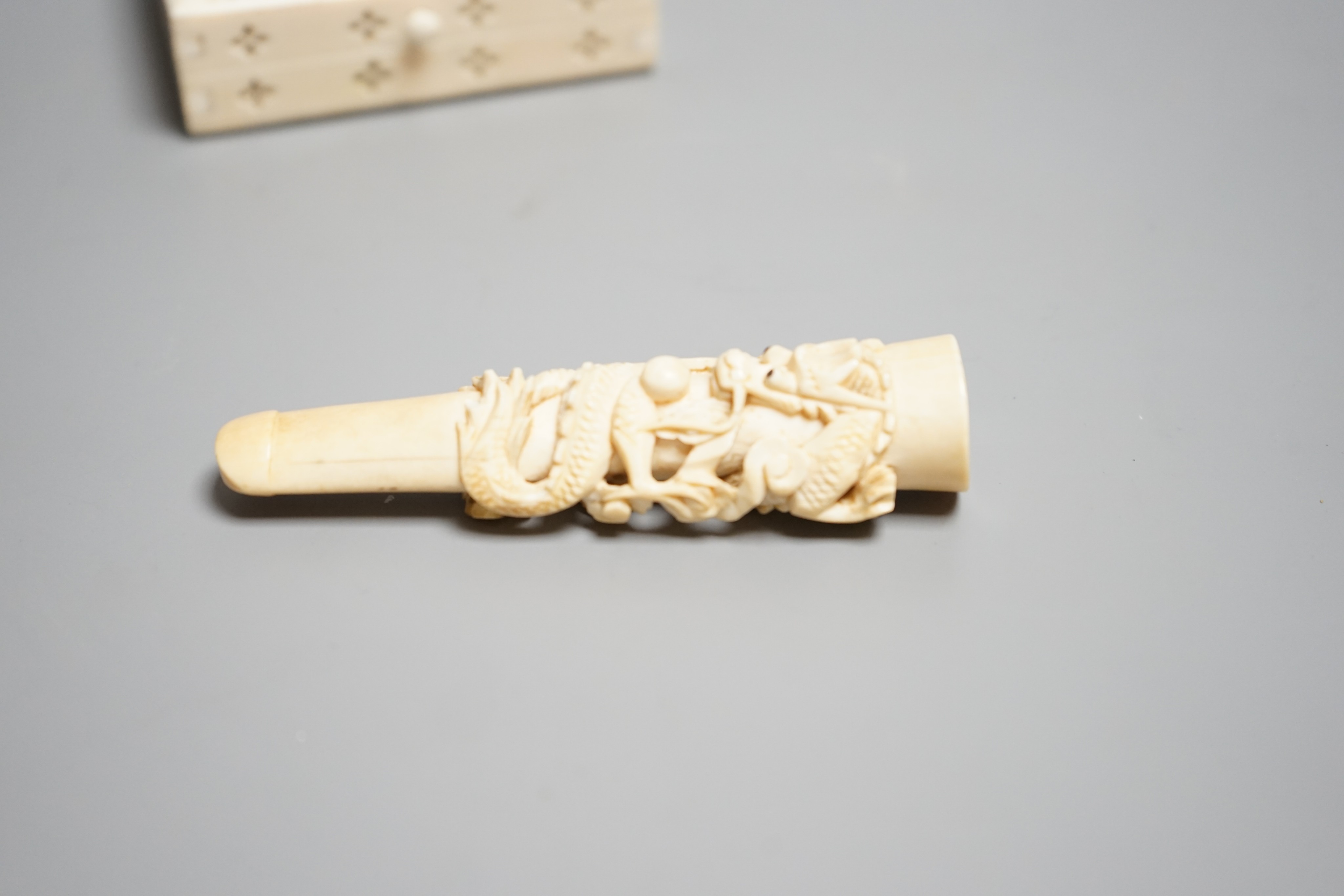 A Chinese ivory cigarette case, 8 x 6cm, and a Chinese carved ivory cheroot holder